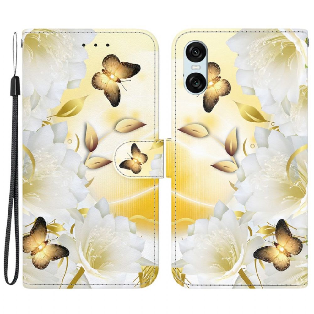 Lederhüllen Sony Xperia 10 Vi Goldene Schmetterlinge Und Weiße Blumen Mit Riemen